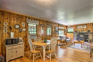 a kitchen and dining room with a table and chairs at Historic Keystone Cabin Near Mount Rushmore! in Keystone