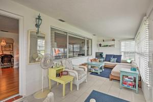 a living room with a couch and a table at Chic Ormond Beach Cottage with Patio - Walk to Ocean in Ormond Beach
