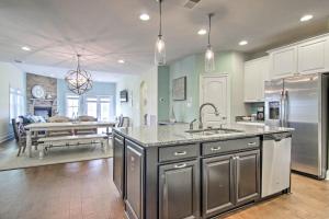 a kitchen with stainless steel appliances and a dining room at 3 Mi to Fenwick Island Beach Luxe Bungalow in Peppers Landing