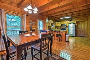 a dining room and kitchen with a table and chairs at Sevierville Cabin with Hot Tub, Grill and Pool Table! in Sevierville