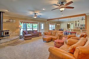 a living room with leather furniture and a fireplace at Spacious Stallion Lake Ranch Home with Patio in Van