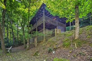 a house on top of a hill in the woods at Tellico Plains Cabin - 25 Acres, Backyard Creek! in Tellico Plains