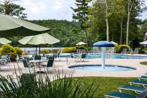 a pool with tables and chairs and a fountain at Lakefront Condo with Pool Access-1min to Big Boulder! in Lake Harmony