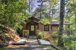 a cabin in the woods with a walkway to the front door at Gatlinburg Home with Hot Tub about 4 Mi to Town! in Gatlinburg
