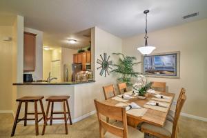 a kitchen and dining room with a table and chairs at Kissimmee Retreat with Pool Access Less Than 4 Mi to Disney! in Orlando