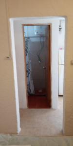 a doorway into a bathroom with a shower in a room at Apartamentos Flor de Lis in La Paloma