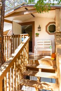 a wooden staircase leading to a porch of a house at Home by Beach 5 - The Treehouse in Naples
