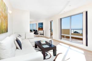 a living room with a white couch and a table at Byala Panorama Resort in Byala