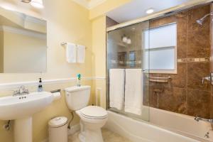 a bathroom with a sink toilet and a shower at Home by Beach 5 - The Treehouse in Naples +19 photos
