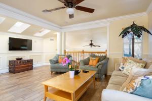 a living room with a couch and a table at Home by Beach 5 - The Treehouse in Naples