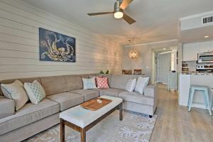 a living room with a couch and a table at St Simons Island Condo with Pool Near Beach, Village in East End