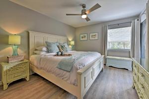 a bedroom with a bed and a ceiling fan at St Simons Island Condo with Pool Near Beach, Village in East End
