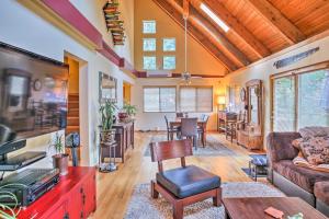 a living room with a couch and a table at Modern South Whidbey House - Steps to Tidal Flats! in Clinton