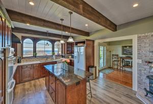a kitchen with wooden cabinets and a stone wall at Waterfront Port Angeles Home with Harbor Views in Port Angeles
