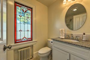 a bathroom with a toilet and a stained glass window at Waterfront Port Angeles Home with Harbor Views in Port Angeles +26 photos