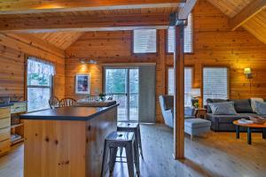 a kitchen and living room in a log cabin at Leavenworth Cabin 3 Mi to Lake Wenatchee Hot Tub! in Leavenworth