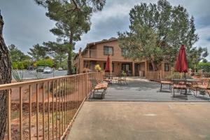a house with a fence and a patio with tables and chairs at South Sedona Condo with Pool Access - Walk to Shops! in Sedona
