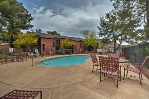 a swimming pool with chairs and a table and a tablektop at South Sedona Condo with Pool Access - Walk to Shops! in Sedona