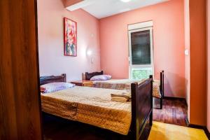 two beds in a room with pink walls at 500 Meter from Grate Beach, App 14 in Ulcinj