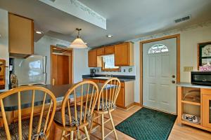 a kitchen and dining room with a table and chairs at Fort Atkinson Cottage on Lake Koshkonong with Deck! in Fort Atkinson
