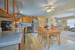 a kitchen with a table and chairs and a dining room at Charming Owls Head Retreat 2 Mi to Rockland Coast in Owls Head