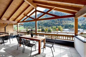 a patio with a table and chairs and a view at Kaprun Glacier Estate in Kaprun