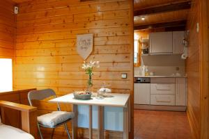 cocina con mesa en una habitación con paredes de madera en Caseta de Fusta, en Aiguafreda