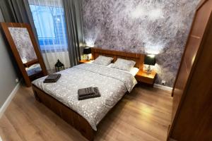 Posteľ alebo postele v izbe v ubytovaní Apartament 56
