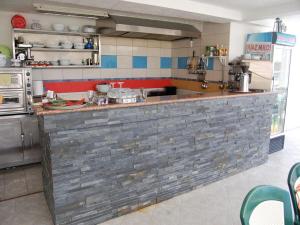a kitchen with a brick counter in a kitchen at 500 Meters from Grate Beach, App 9 in Ulcinj +28 photos