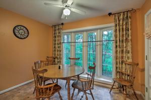 a dining room with a table and chairs and a clock at Spacious Family Home - 17 Miles to Winston-Salem! in Lewisville