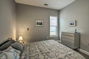 a bedroom with a bed and a dresser and a window at Heart of the Brooklyn Arts District Urban Gem! in Wilmington