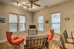 a dining room with a table and chairs and windows at Chic Wilmington Condo in Brooklyn Arts District! in Wilmington