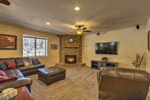 a living room with leather furniture and a fireplace at 3 Mi to Rainbow Lake Home with Hot Tub and Deck in Pinetop-Lakeside