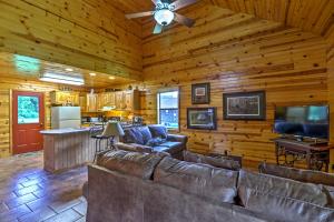 a living room with leather couches and a flat screen tv at Dream Valley Mountain View Cabin with Covered Porch! in Mountain View