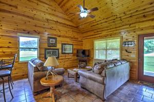 a living room with leather furniture and a ceiling fan at Dream Valley Mountain View Cabin with Covered Porch! in Mountain View