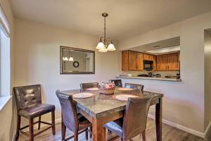 a kitchen and dining room with a table and chairs at Canyon Mesa Golf Condo with Majestic Mountain Views! in Sedona