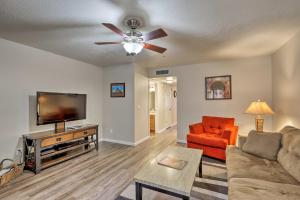 a living room with a couch and a flat screen tv at Canyon Mesa Golf Condo with Majestic Mountain Views! in Sedona