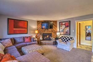 a living room with a couch and a fireplace at Downtown Breck Condo on Main St - Walk to Slopes in Breckenridge