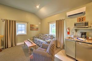 a living room with a couch and a kitchen at Branson Cottage with Pool Access about 2 Mi to the Strip in Branson