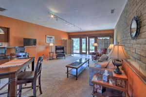 a living room with a couch and a table at Quiet Prescott Forest Retreat Cottage with Patio! in Prescott