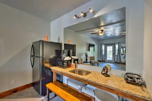 a kitchen with a sink and a refrigerator at Lava Hot Springs Studio - Walk to Portneuf River! in Lava Hot Springs