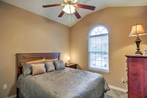 a bedroom with a ceiling fan and a bed at Branson Home with Deck Walk to The Strip and Creek! in Branson