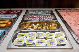 a buffet of food on a table with meat at Hotel Chambord in Brussels