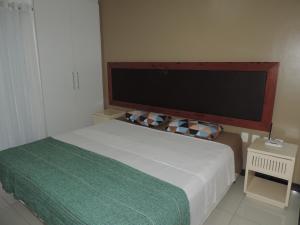 um quarto com uma cama e uma grande televisão na parede em Eco Paradise Temporada Aconchegante - Joana Vasconcelos em Cumbuco