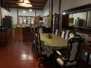 a dining room with a table and chairs and a kitchen at Villa Mistika in Zorritos
