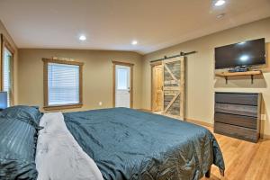 a bedroom with a bed and a flat screen tv at Spacious Kunkletown Home with Full Game Room and Deck! in Kunkletown