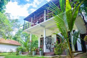 a house with a balcony on top of it at King's Elephant Cabanas & Restaurant in Tangalle