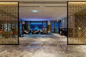 a lobby with a large screen in the middle of a building at Osaka Excel Hotel Tokyu in Osaka