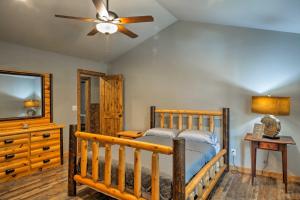 a bedroom with a crib and a ceiling fan at Summerville Getaway with Deck and On-Site Creek! in Summerville