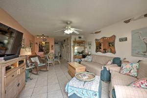 a living room with a couch and a tv at St Augustine Resort Condo - Walk to Crescent Beach in Saint Augustine